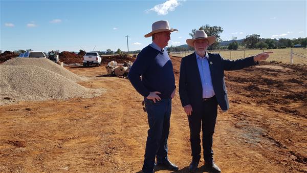 Federal Member for New England Barnaby Joyce and Tamworth Region Mayor Russell Webb at the commencement of works on the road upgrade. They are standing on red dirt and looking out at the project.