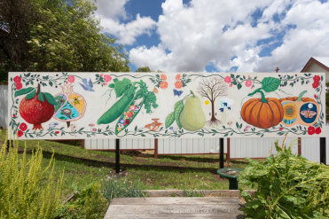 Nundle Community  Garden Mural featuring radish, pumpkin and ther vegetables amongst vines, on a white background